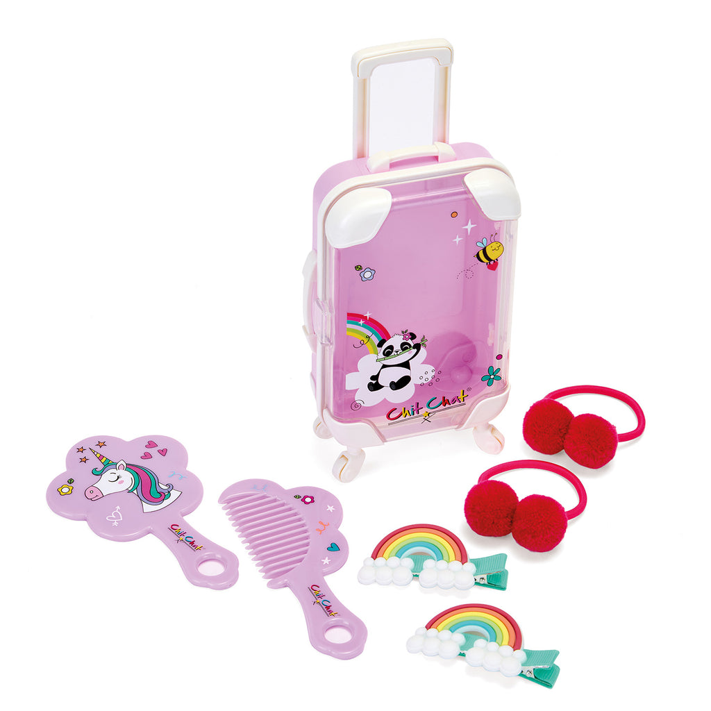 Lilac toy suitcase with hair accessories on a white background