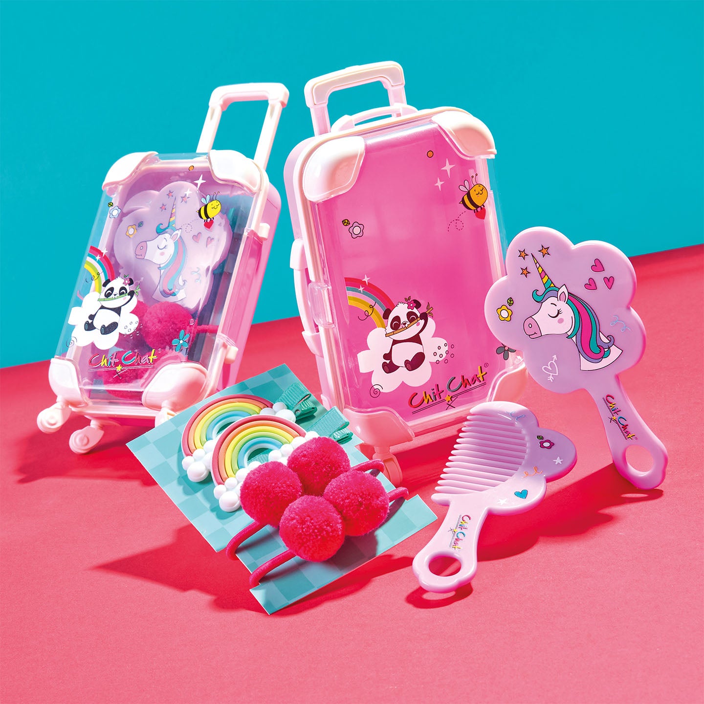 Children's toy suitcase with hairbrush, and other accessories on a pink and blue background
