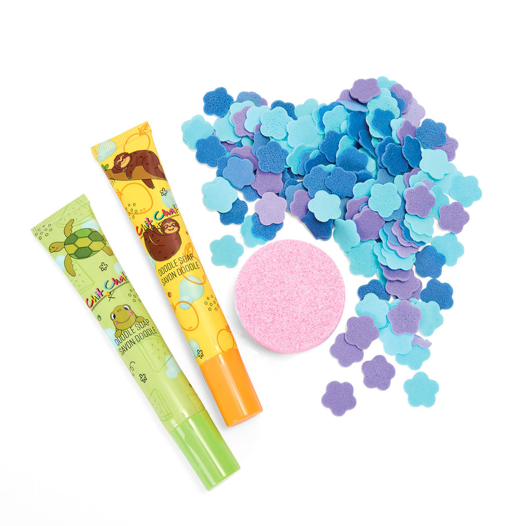 Colorful foam confetti with two doodle soaps and a bath fizzer on a white background