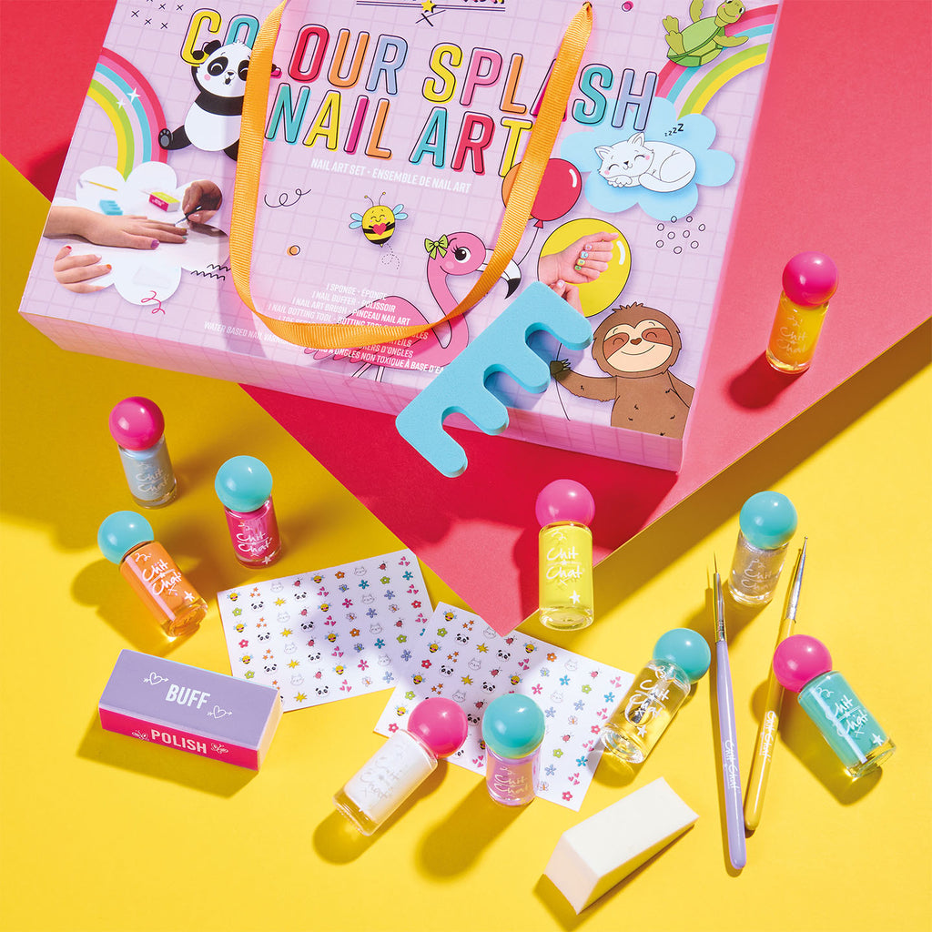 Colourful nail art kit with bottles, tools, and a box on a pink and yellow background