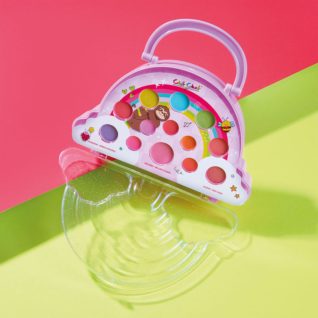 Colourful makeup set with purpley pink handle on a pink and green background