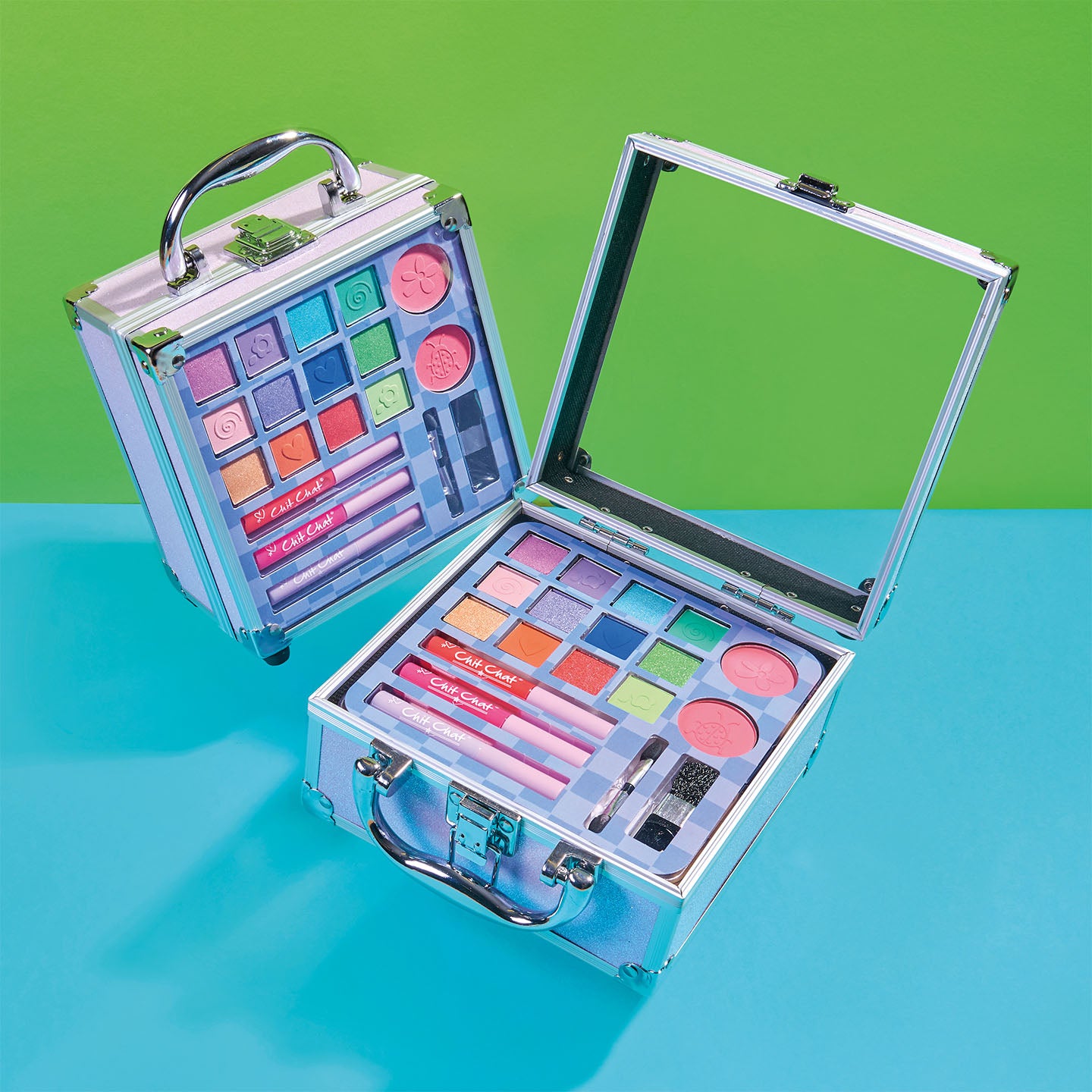 Children's makeup set with colourful palettes and tools on a green and blue background